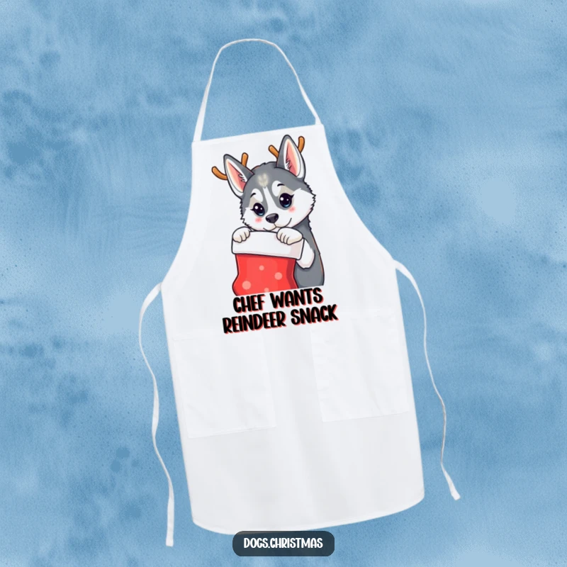 Funny apron featuring a husky dog wearing reindeer antlers, curiously eyeing a Christmas stocking, perfect for a festive cook.