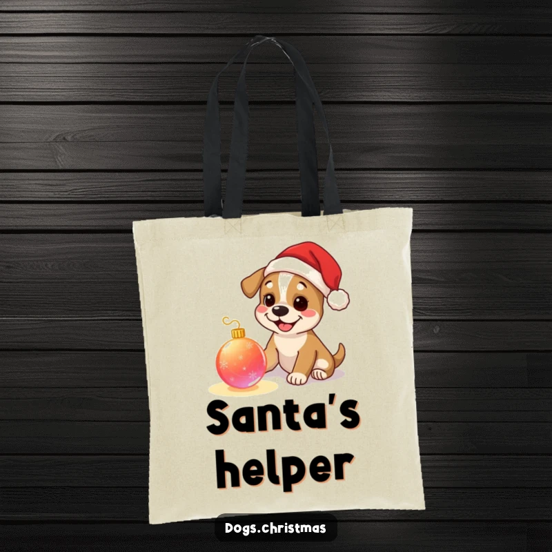 Funny dog tote bag, happy pup wearing tiny Santa hat, playing with a glowing Christmas ornament, perfect for holiday shopping.